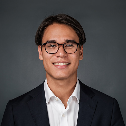 portrait of Ben Scott. He is wearing a white blouse with a black blazer