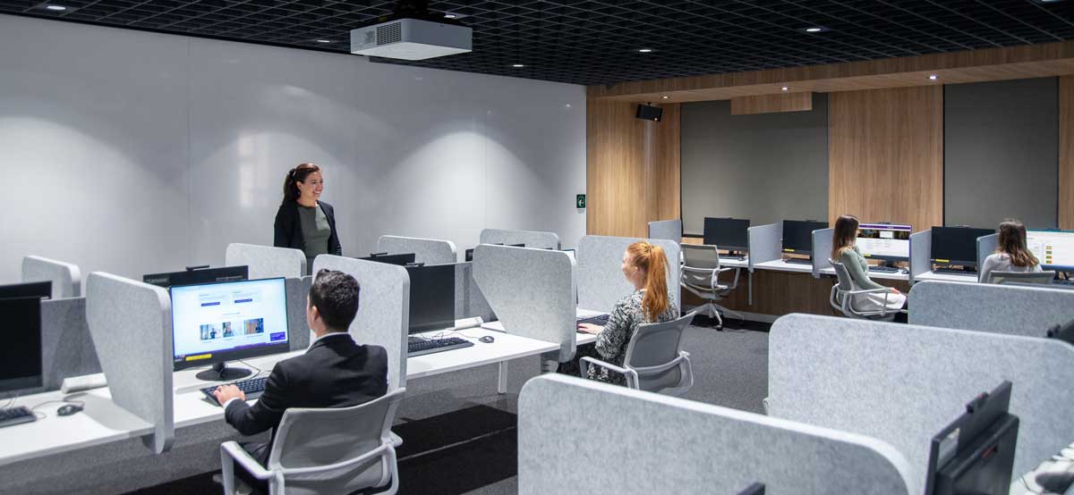 interior of BESC lab showing partitioned computers and projector and white wall