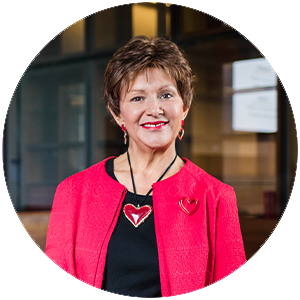 Profile photo of Professor Bronwyn Fredericks standing in the UQ Law library