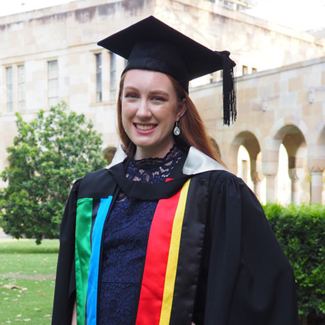 Tiana Stuart in graduation gown in the UQ Great Court