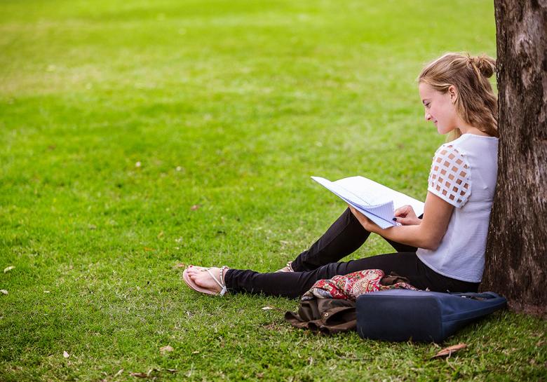 Kate Green sitting under a tree at UQ