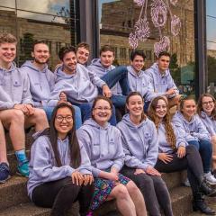 School of Economics Honours students sitting together in from of the UQ Art Museum