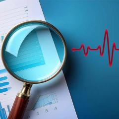 Magnifying glass over document with EKG line to the right