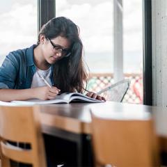 girl studying at a desk. 
