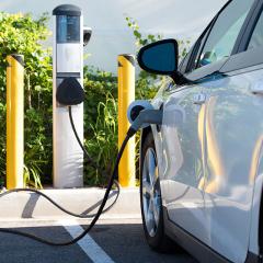 Electric vehicle plugged into a charging station 