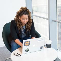 woman sitting down with laptop working